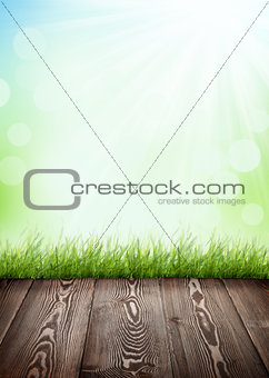 Summer background with wooden floor, green grass and bokeh
