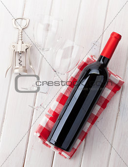 Red wine bottle, glasses and corkscrew