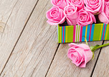Valentines day background with gift box full of pink roses