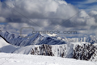 Winter snowy mountains in clouds