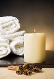Spa massage border background with towel stacked and candle with spices and cinnamon flavor