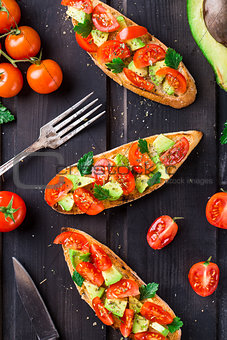 Bruschetta with tomato, avocado and herbs