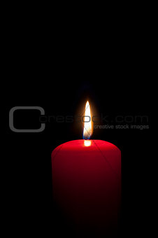 red candles lighting in the darkness