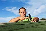 Man finishing installing the bitumen roof shingles
