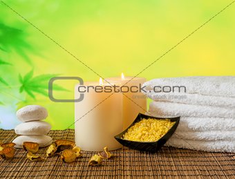 Spa massage border background with towel stacked, candles and sea salt