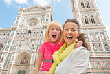Portrait of happy mother and baby girl in front of duomo in flor