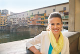 Portrait of smiling young woman near ponte vecchio in florence, 