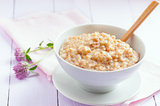 Oatmeal in a bowl on the table, selective focus
