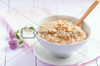 Oatmeal in a bowl on the table, selective focus