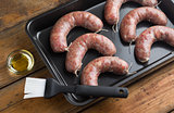 Raw homemade sausages in a pan