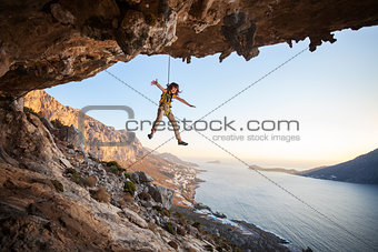 Seven-year old girl hanging on rope while lead climbing