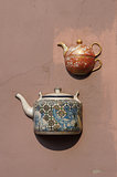 Ancient teapots on facade of old building in Vilnius, Lithuania.