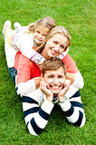 Husband, wife and child piled on each other