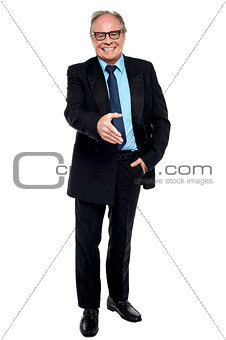 Joyous businessman extending his hand