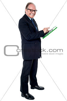 Cheerful senior businessman using a calculator