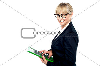 Bespectacled entrepreneur using a calculator