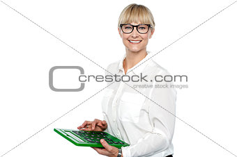 Secretary using large green calculator
