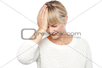 Sad middle aged woman suffering from headache