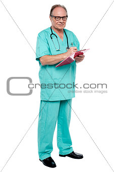 Male doctor in duty hours writing prescription