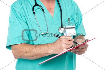 Medical expert jotting down case sheet notes