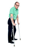Physically disabled old man with crutches
