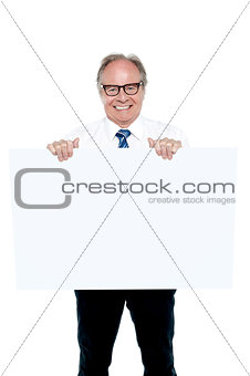 Senior marketing manager holding up a blank ad board