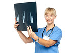 Lady surgeon holding up x-ray report