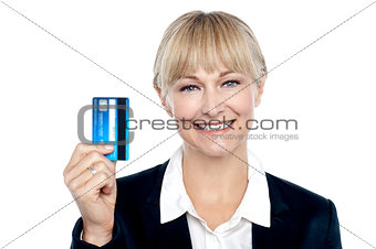 Joyous female employee showing credit card