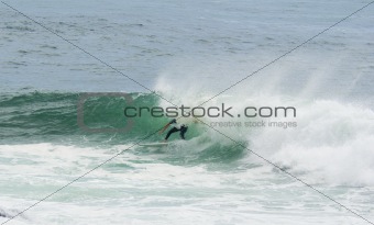 surfer surfing dump wave