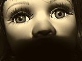 the face of toy doll. sepia