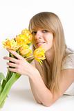 Sexy girl with bright yellow tulips in hands