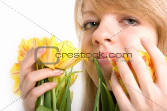 Sexy girl with bright yellow tulips in hands