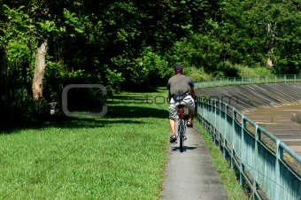 man cycling along the drains