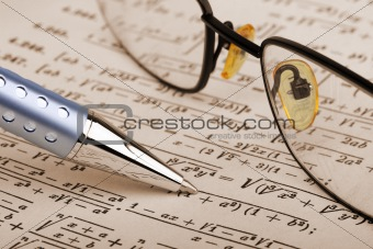 Pen and glasses over math page