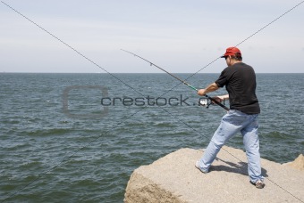 Man fishing on a rock