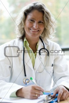 female medical professional writing
