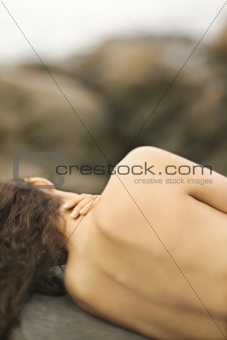 Nude woman on rock.