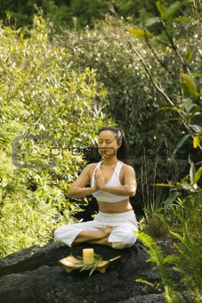Asian woman meditating.