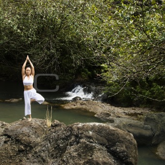 Asian woman doing yoga.
