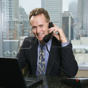 Businessman on phone in office.