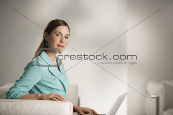 Woman working on laptop.