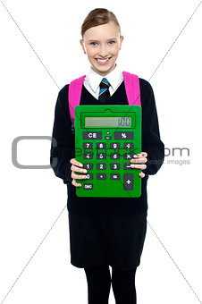 School girl holding large green calculator