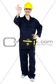 Female worker in jumpsuit showing perfect gesture