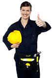 Woman in builder uniform showing thumbs up