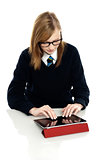 Bright teen student using a tablet device
