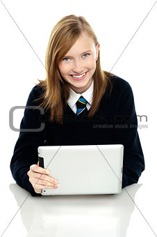 Pretty schoolgirl holding newly launched tablet pc