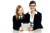 Teacher and student holding tablet device together