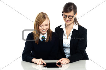 Educator and student exploring a tablet device