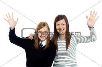 Mum and daughter waving hands at the camera