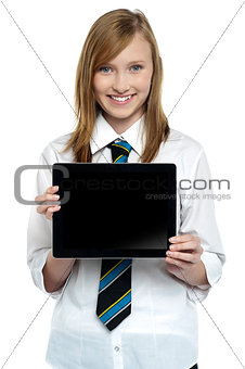Pretty college girl displaying a tablet device